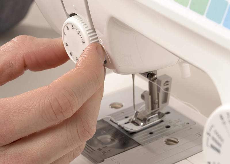 checking the tension dial on sewing machine