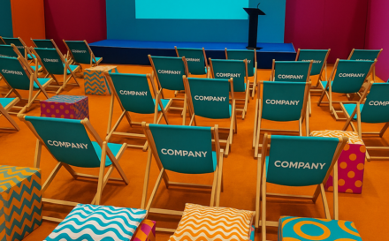 Elaborate Custom branded set design featuring seating in a lively event theatre space